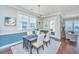 Bright dining room with modern lighting, comfortable seating, and access to an outdoor area, ideal for entertaining guests at 1545 Calaveras Cir, Mount Pleasant, SC 29466