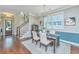 Elegant dining room featuring a stylish table with seating, modern lighting, and views of the staircase and front entry at 1545 Calaveras Cir, Mount Pleasant, SC 29466