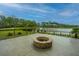Outdoor brick firepit with lakeside views, ideal for relaxing and entertaining guests at 1545 Calaveras Cir, Mount Pleasant, SC 29466