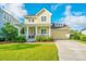 Inviting two-story home boasting a classic front porch, manicured landscaping, and a convenient attached garage, perfect for families at 1545 Calaveras Cir, Mount Pleasant, SC 29466