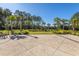Community green space with adirondack chairs, mature trees, and walking paths, perfect for relaxation and outdoor activities at 1545 Calaveras Cir, Mount Pleasant, SC 29466
