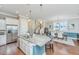 Well-lit kitchen featuring stainless steel appliances, an island with seating, and a clear view of the staircase at 1545 Calaveras Cir, Mount Pleasant, SC 29466