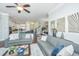 Spacious living room with gray sofas, a coffee table, and access to the kitchen and dining area at 1545 Calaveras Cir, Mount Pleasant, SC 29466