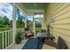 Cozy screened porch with wicker furniture, table, and view of the garden at 1545 Calaveras Cir, Mount Pleasant, SC 29466