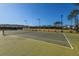 Community tennis court with lighting for nighttime play and perimeter fencing at 1545 Calaveras Cir, Mount Pleasant, SC 29466