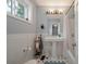 Charming bathroom with white subway tiles, a pedestal sink, and black-and-white checkered floors at 1603 Culpepper Cir, Charleston, SC 29407