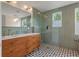 Stylish bathroom features a double vanity, patterned tile floors, and a glass-enclosed shower at 1603 Culpepper Cir, Charleston, SC 29407