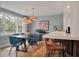 Bright dining room featuring a modern table with blue chairs and stylish pendant lighting, adjoining the kitchen at 1603 Culpepper Cir, Charleston, SC 29407