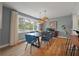 Bright dining room features modern lighting, stylish blue chairs, and a large window at 1603 Culpepper Cir, Charleston, SC 29407