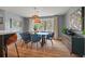 Cozy dining area with a modern table, ample natural light, and a view into the kitchen at 1603 Culpepper Cir, Charleston, SC 29407