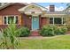 A lovely red brick home entrance with stylish wood-accented shutters and a bright blue door at 1603 Culpepper Cir, Charleston, SC 29407