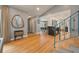 Inviting entryway with hardwood floors, stylish mirror, and unique decor with an open view to the dining and kitchen areas at 1603 Culpepper Cir, Charleston, SC 29407