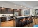 Stylish kitchen with a spacious island, seating, and stainless steel appliances, seamlessly connecting to the living area at 1603 Culpepper Cir, Charleston, SC 29407