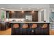 Updated kitchen featuring a large island with seating, dark wood cabinets, stainless steel appliances, and bright lighting at 1603 Culpepper Cir, Charleston, SC 29407