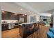 Modern kitchen with a large island, stainless steel appliances, dark wood cabinetry, and an open floor plan to the living area at 1603 Culpepper Cir, Charleston, SC 29407