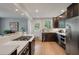 Well-equipped kitchen boasting a gas cooktop, stainless steel appliances, and seamless flow to the dining area at 1603 Culpepper Cir, Charleston, SC 29407