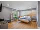Large main bedroom with scenic mural, light wood floors, and a sun-filled window at 1603 Culpepper Cir, Charleston, SC 29407