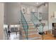 Unique staircase with blue railings leading to the next level, adjacent to the brick fireplace at 1603 Culpepper Cir, Charleston, SC 29407