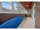 Bright sunroom featuring tiled flooring, brick accents, and multiple windows offering abundant natural light at 1603 Culpepper Cir, Charleston, SC 29407