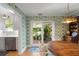 Dining area featuring a wooden table, bright wallpaper and sliding glass doors to patio at 166 1/2 Queen St, Charleston, SC 29401