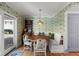 Cozy dining nook with built-in seating, bright wallpaper, wooden table and hardwood floors at 166 1/2 Queen St, Charleston, SC 29401