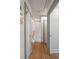 Hallway with hardwood floors and gray trimmed doors and walls at 166 1/2 Queen St, Charleston, SC 29401