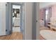 Hallway view to a bathroom with floral wallpaper and a pink Bedroom at 166 1/2 Queen St, Charleston, SC 29401