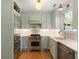 Updated kitchen featuring stainless steel appliances, bright white countertops, and ample cabinet space at 166 1/2 Queen St, Charleston, SC 29401