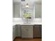 Bright kitchen with stainless steel appliances and a view of the outdoor through the window at 166 1/2 Queen St, Charleston, SC 29401
