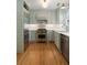 Bright, updated kitchen with stainless steel appliances, custom cabinetry, and hardwood floors at 166 1/2 Queen St, Charleston, SC 29401