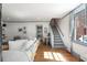 Open-concept living area featuring hardwood floors, white sofa, and blue accents at 166 1/2 Queen St, Charleston, SC 29401