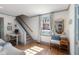 Bright room with hardwood floors, staircase, large window and comfortable seating area at 166 1/2 Queen St, Charleston, SC 29401