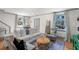 Comfortable living room with white sofa, patterned rug, and ample natural light at 166 1/2 Queen St, Charleston, SC 29401