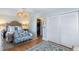 Bright main bedroom featuring hardwood floors, white furniture, and a unique ceiling fan at 166 1/2 Queen St, Charleston, SC 29401
