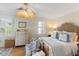 Bright main bedroom featuring hardwood floors, white furniture, and a unique ceiling fan at 166 1/2 Queen St, Charleston, SC 29401