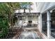 Outdoor kitchen with stainless steel appliances, pizza oven, and brick patio, perfect for entertaining at 166 1/2 Queen St, Charleston, SC 29401