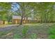 View of the house and spacious backyard with mature trees and lush greenery at 169 Southwold Cir, Goose Creek, SC 29445