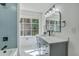 This bathroom has a marble countertop, a gray vanity, and a view of outside from the window at 169 Southwold Cir, Goose Creek, SC 29445