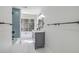 Well-lit bathroom featuring a modern vanity, marble floors, and a bathtub with stylish blue tile at 169 Southwold Cir, Goose Creek, SC 29445