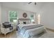 Bright bedroom with a decorative headboard, light wood floors, area rug and sitting area by large window at 169 Southwold Cir, Goose Creek, SC 29445