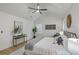 Bedroom with a ceiling fan, white walls, light wood floors, decorative headboard and sitting area at 169 Southwold Cir, Goose Creek, SC 29445
