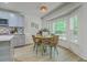 Sunlit dining area with a round table, wicker chairs, and views of the lush backyard at 169 Southwold Cir, Goose Creek, SC 29445