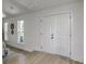 Bright entryway featuring double doors, luxury vinyl plank flooring, and decorative mirrors at 169 Southwold Cir, Goose Creek, SC 29445