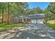 Charming brick ranch home with a two-car garage, mature trees, and long driveway at 169 Southwold Cir, Goose Creek, SC 29445