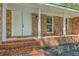 Charming front porch with brick stairs, brick siding, white columns and a white double door at 169 Southwold Cir, Goose Creek, SC 29445