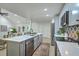Open kitchen with stainless appliances, island seating, and seamless transition into the living area at 169 Southwold Cir, Goose Creek, SC 29445