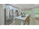 Well-lit kitchen boasts stainless steel appliances, an island with bar seating, and views of the backyard at 169 Southwold Cir, Goose Creek, SC 29445