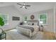 Sun-filled main bedroom boasts large windows, a ceiling fan, and modern décor at 169 Southwold Cir, Goose Creek, SC 29445