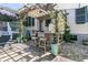 Backyard patio has a charming pergola with bar seating and lush greenery at 1761 Old Military Rd, Charleston, SC 29412