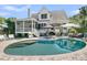 Inviting backyard features a sparkling pool, lush landscaping, and ample seating for outdoor relaxation and enjoyment at 1761 Old Military Rd, Charleston, SC 29412